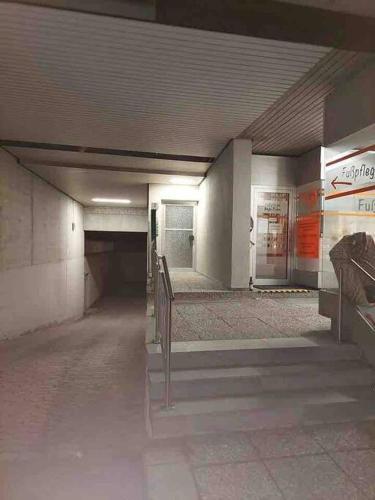 an empty hallway of a subway station with benches at Apartment 55 I Cental Hof I WiFi I TV in Hof