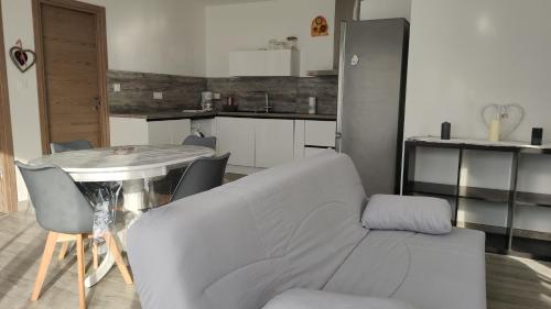 a living room with a couch and a table at Jolie petite maison à 50 mètres de la plage in Cap d'Agde