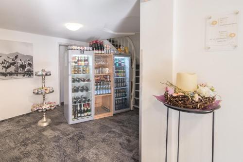 a room with a refrigerator filled with wine bottles at bichl 761 in Fischen