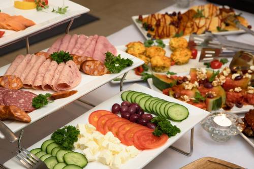 a buffet of different types of food on trays at Flamingo Villas Boutique Hotel in Walvis Bay