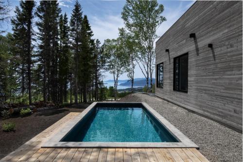 - une piscine dans l'arrière-cour d'une maison dans l'établissement Luxurious Chalet with Pool, Sauna, Spa & Amazing View, à La Malbaie