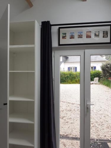a sliding glass door with a view of a yard at Manoir de l'As de Trèfle in Isneauville