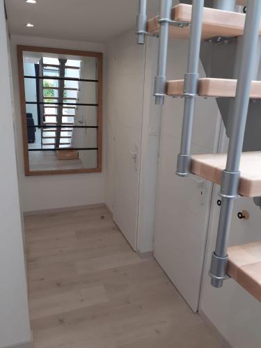 a hallway with a mirror and a staircase in a room at Manoir de l'As de Trèfle in Isneauville