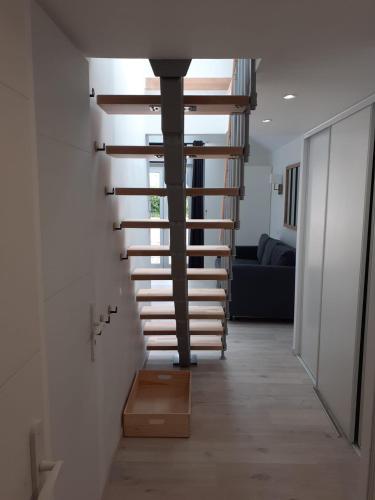 a spiral staircase in a house with a living room at Manoir de l'As de Trèfle in Isneauville