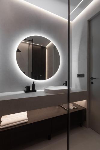 a bathroom with a sink and a mirror at Étoile apartment in Šibenik
