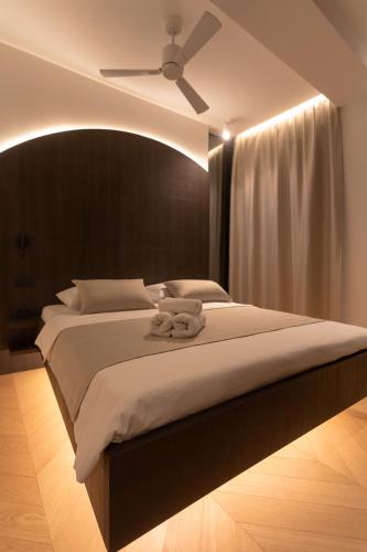 a bedroom with a large bed with a ceiling fan at Étoile apartment in Šibenik