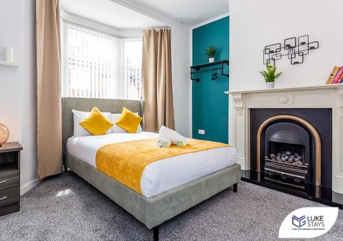 a bedroom with a bed and a fireplace at Luke Stays - Kitchener Street in Sheriff Hill