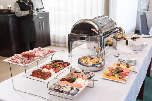 a table with many different types of food on it at Flamingo Villas Boutique Hotel in Walvis Bay