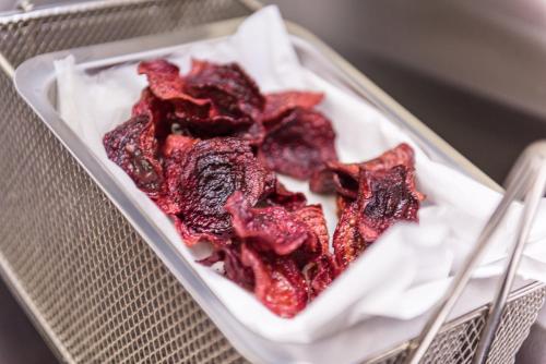 a container filled with red food in a basket at Flamingo Villas Boutique Hotel in Walvis Bay