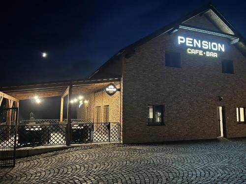 a brick building with a sign on it at night at Pension Libá in Libá