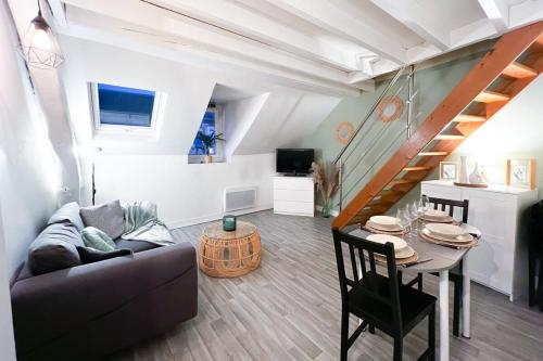 - un salon avec un canapé et une table dans l'établissement Appart'Hôtel BELLE HELENE Calme & Chic, à Montereau-faut-Yonne