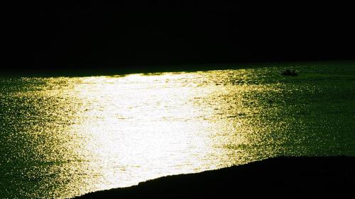 a body of water with a boat in it at Dar Tifrouine in Lalla Takerkoust