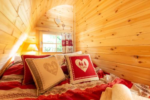 a bedroom with a bed in a log cabin at Le Cocoon Asniérois in Asnières-sur-Vègre