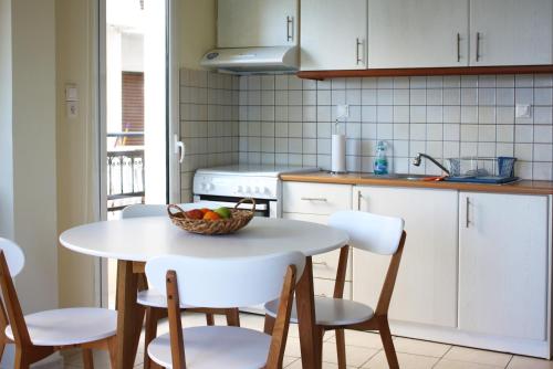 a kitchen with a table with a bowl of fruit on it at Thalassa in Agios Nikolaos