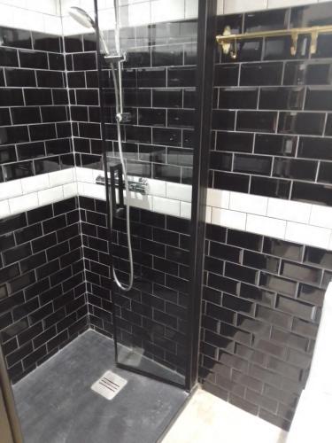 a shower with a glass door in a bathroom at LE GEORGE SAND Elégant studio coeur historique in Bourges