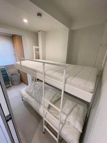 a bedroom with two bunk beds in a room at Les abeilles in Knokke-Heist