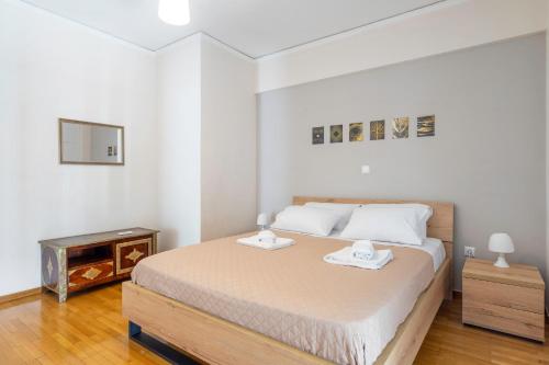 A bed or beds in a room at Penthouse in the heart of Athens / Koukaki area