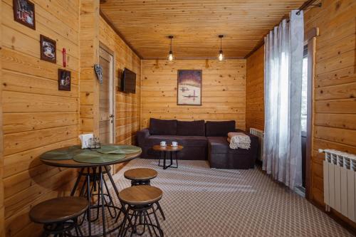 a living room with a couch and a table at ЕкоСадиба Пан Атаман in Skhidnitsa