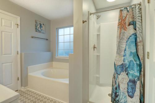 a bathroom with a tub and a shower at Pooler Travelers Retreat V - Entire House - in Savannah