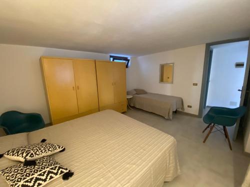 a small bedroom with two beds and a window at Casa Teresa in Porto Pino