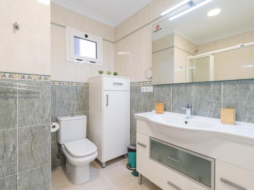 a bathroom with a white toilet and a sink at Rejon Home By CanariasGetaway in Las Palmas de Gran Canaria