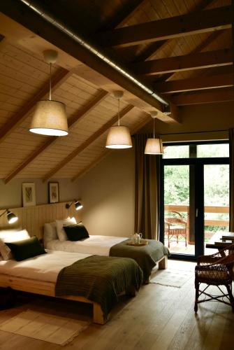 a bedroom with a large bed and two pendant lights at Witoszyn28 in Kazimierz Dolny