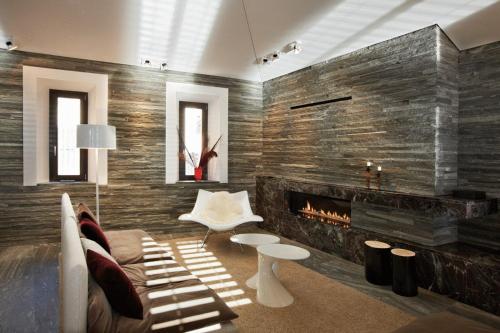 a living room with a couch and a fireplace at Seven Apartments in Ascona