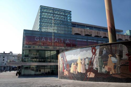 a large glass building with a mural in front of it at Morali Palace in Genova