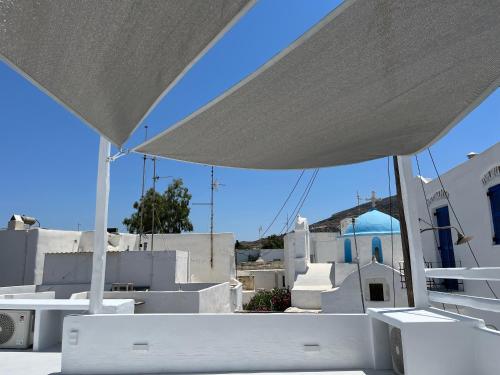 a view of a building from under a white umbrella at Cycladic Rooftop House in the Heart of Parikia in Parikia