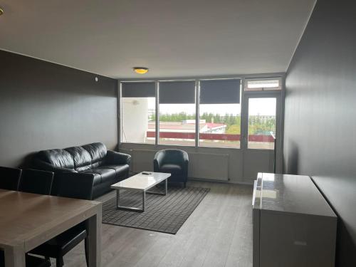 a living room with a couch and a table at Reykjavík Condo in Reykjavík