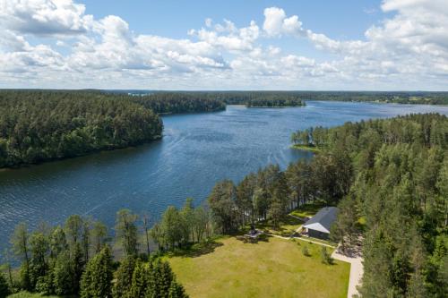 an aerial view of a lake with a house at Villa The Lake in Mindūnai