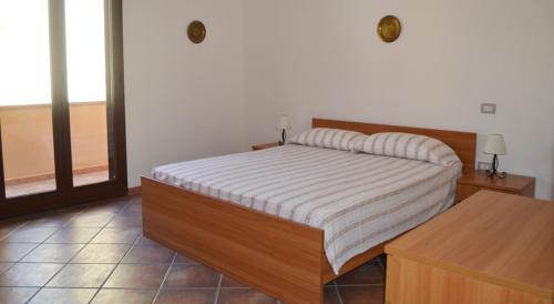 Кровать или кровати в номере Appartamenti famiglia Pinna - Villa Serena -