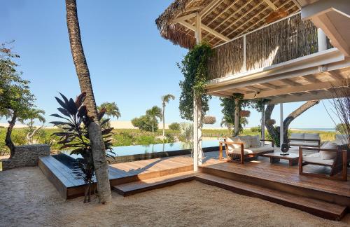 a porch of a house with a view of the ocean at Villa Praia - La Villa Group in Jericoacoara