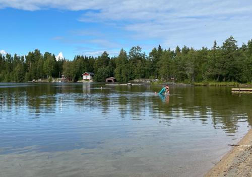 a person is in the water in a lake at HusHotellHunge AB in Bräcke