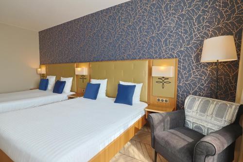En eller flere senge i et værelse på Dream Castle Hotel Marne La Vallee
