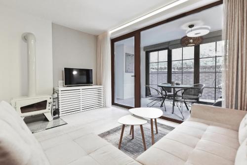 a living room with a couch and a table at Apartmentai "Nidos Vilnelė" in Nida