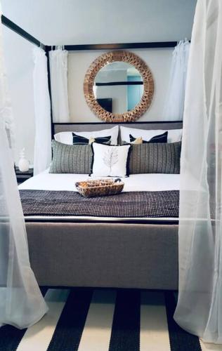 a bedroom with a bed with a mirror on it at Tropical Oasis by the beach and shops, with pool in Riviera Beach