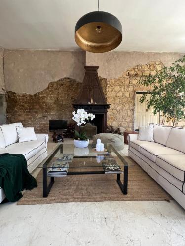 a living room with a couch and a coffee table at Anexo Casa São Miguel the beauty of imperfection in Santarém