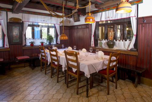 a dining room with a long table and chairs at Pension Lectar in Radovljica