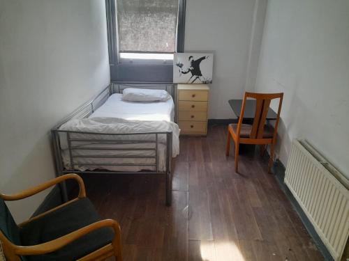 A bed or beds in a room at Woolwich Backpackers New