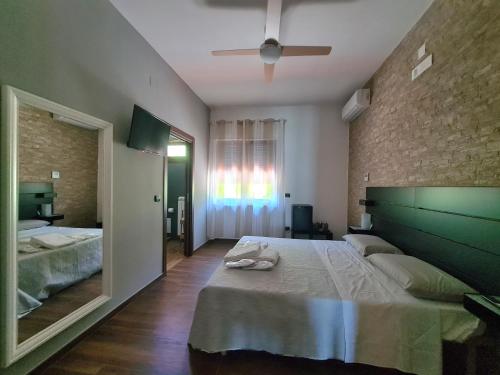 a bedroom with a large bed and a large mirror at Rossi&Nero Resort - servizi extra a pagamento Ristorante Piscina Sauna Spa in Pasquarelli