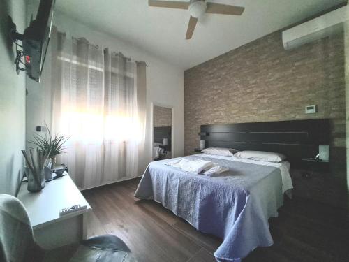 a bedroom with a large bed and a window at Rossi&Nero Resort - servizi extra a pagamento Ristorante Piscina Sauna Spa in Pasquarelli