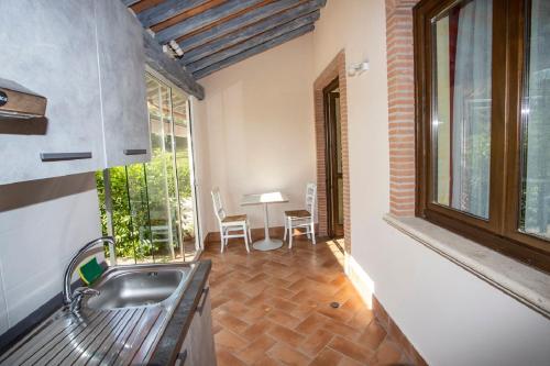 a kitchen with a sink and a table and a window at Agriturismo Il Bagolaro in Nerola