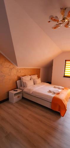 a bedroom with a large bed and a ceiling at Pensiunea Cheile Bicazului in Bicaz Chei