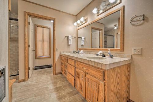 a bathroom with a sink and a large mirror at Wraparound Deck and Pool Access Truckee Cabin in Truckee