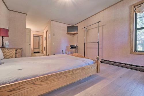 a bedroom with a bed and a tv on the wall at Wraparound Deck and Pool Access Truckee Cabin in Truckee