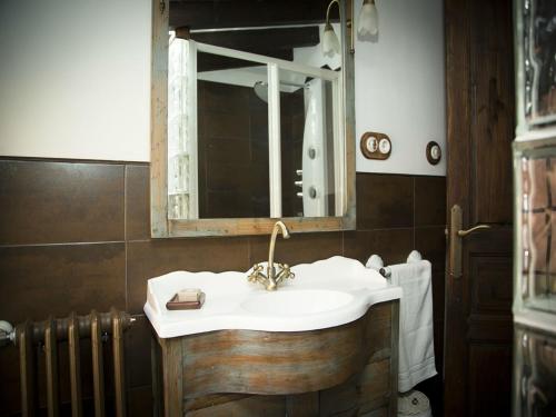 a bathroom with a sink and a mirror at El Requexu, apartamentos a 900 m de la playa de Poo AR-0474-AS in Llanes
