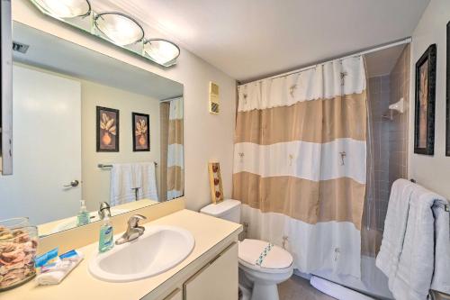 a bathroom with a sink and a toilet and a shower at Beachfront Marco Island Condo with Pool Access! in Marco Island