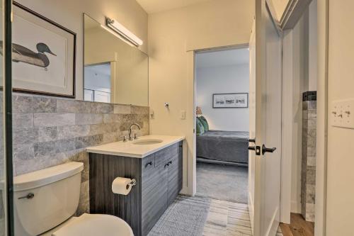 a bathroom with a toilet and a sink and a mirror at Grand Lake Condo with Balcony and Mountain Views in Grand Lake