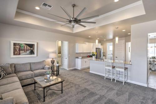 a living room with a couch and a table and a kitchen at Idyllic Kingman Retreat with Yard - Near Hiking in Kingman